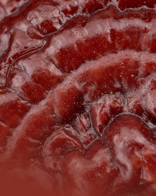 Deep red reishi mushroom cap in close-up — calming skincare for redness-prone skin from Mushroom Envy