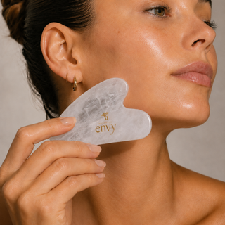 Gua sha stone sculpting the cheek and jawline, step three of the Mushroom Envy ritual